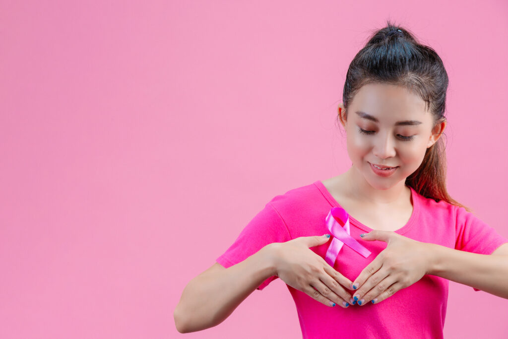 breast cancer awareness month, woman in pink t shirt with satin