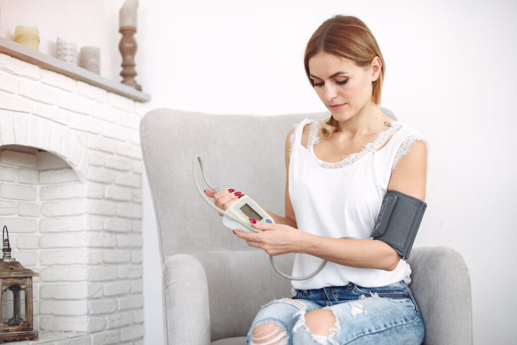 woman measures herself pressure at home