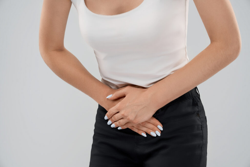 woman suffering from pain in lower abdomen.